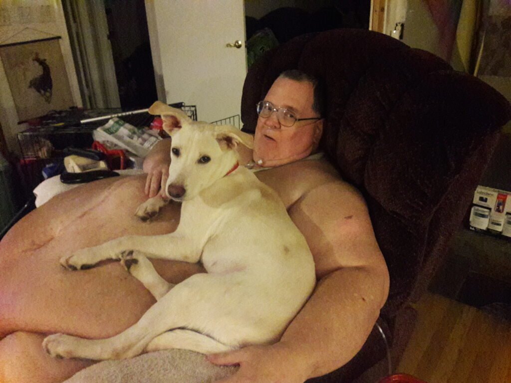 Dog sitting and sleeping on its owner lap on the couch